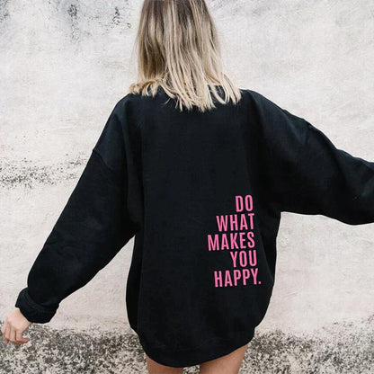 Model with blonde hair seen from behind in a loose black sweatshirt with a pink slogan printed low on the back. 4