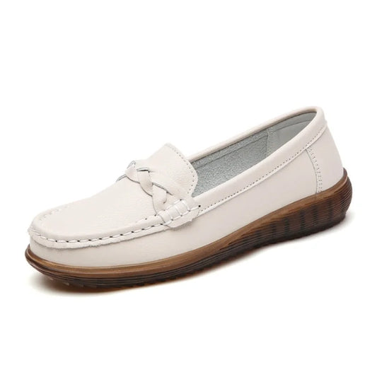 Single cream loafer on a white background, angled to show the plaited strap, contrast stitching and thick ridged brown sole. 1