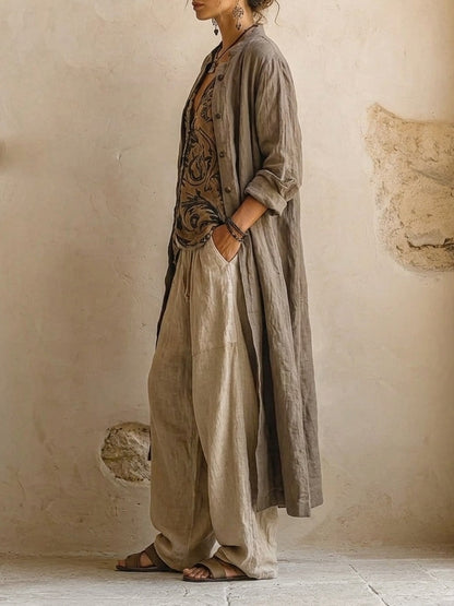 Side view of the long open taupe linen coat with rolled sleeves, worn over the top and trousers 4
