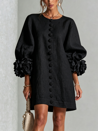 Front view of the black version on a model, with floral buttons and large flower-trimmed puffed sleeves. 15
