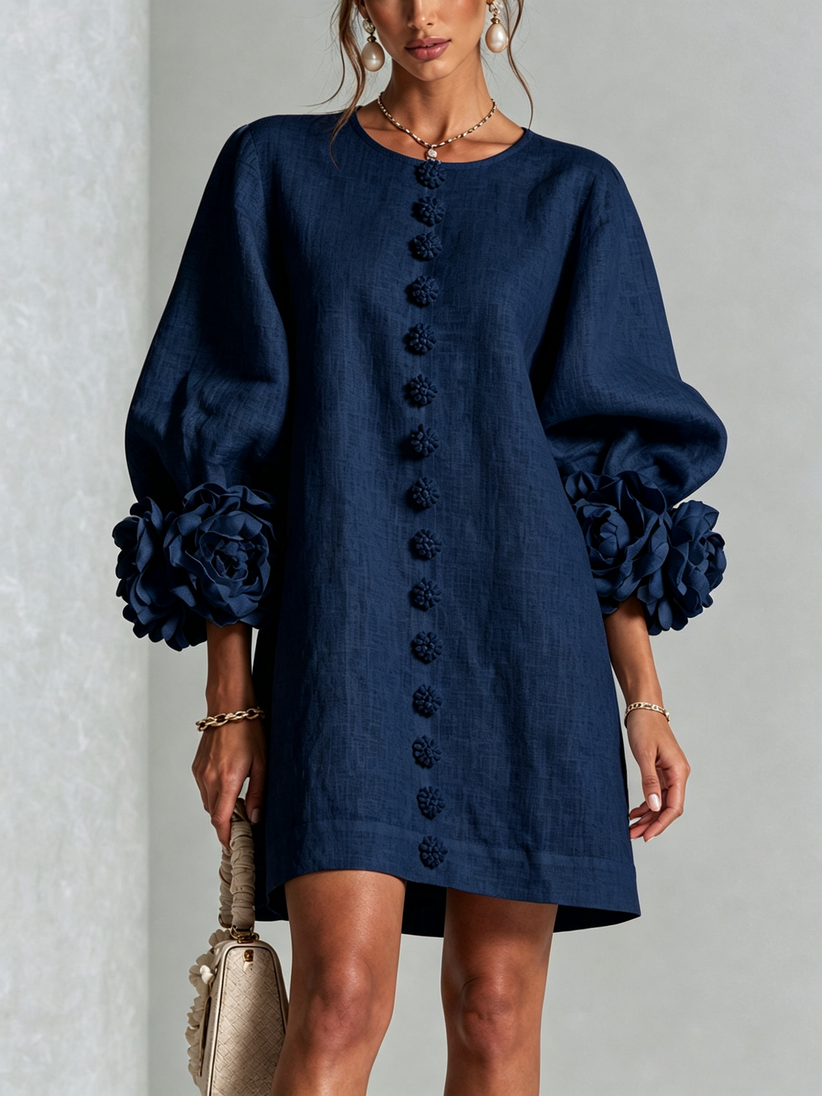 Front view of the navy blue version on a model, with flower buttons down the front and rose-trimmed puffed sleeves. 11