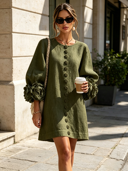 Model in the olive green dress outdoors, wearing sunglasses and holding a takeaway coffee on a sunny pavement. 10