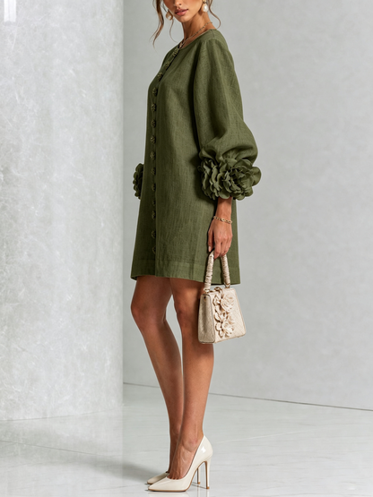Side view of the olive green dress on a model with a cream handbag, showing the balloon sleeve and flower cuff. 8