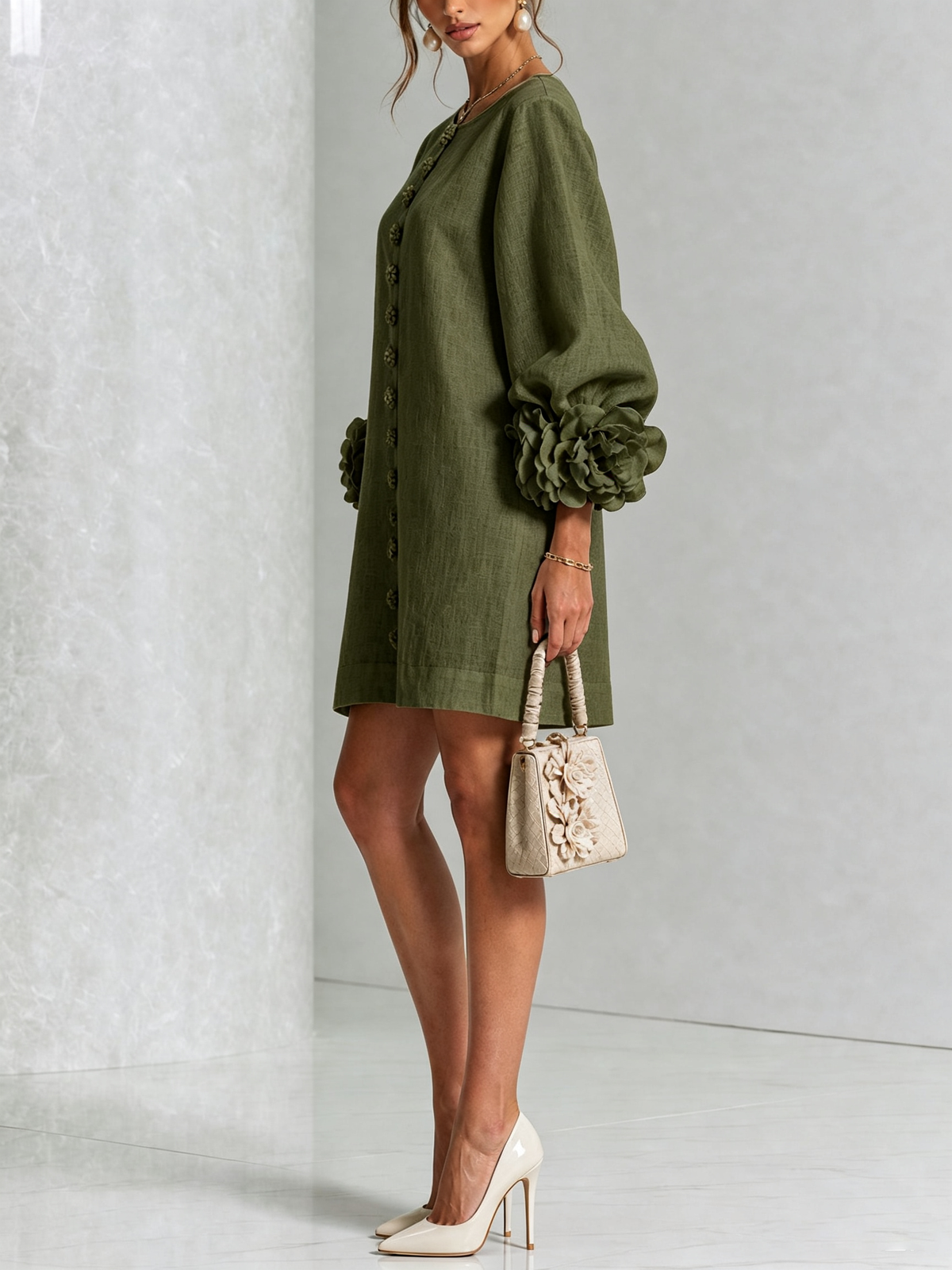Side view of the olive green dress on a model, showing the puffed sleeve with its large fabric rose cuff. 8