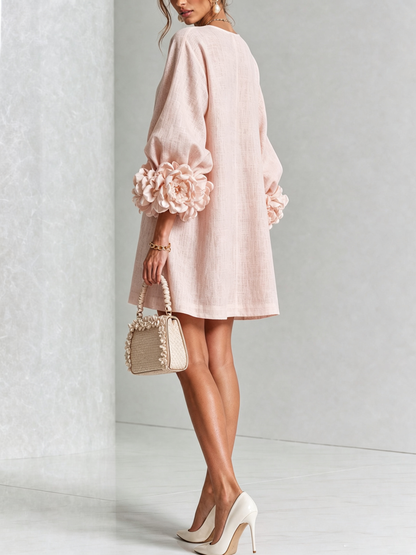 Rear three-quarter view of the pale pink dress, showing puff sleeves with large rose cuffs, worn by a model 21
