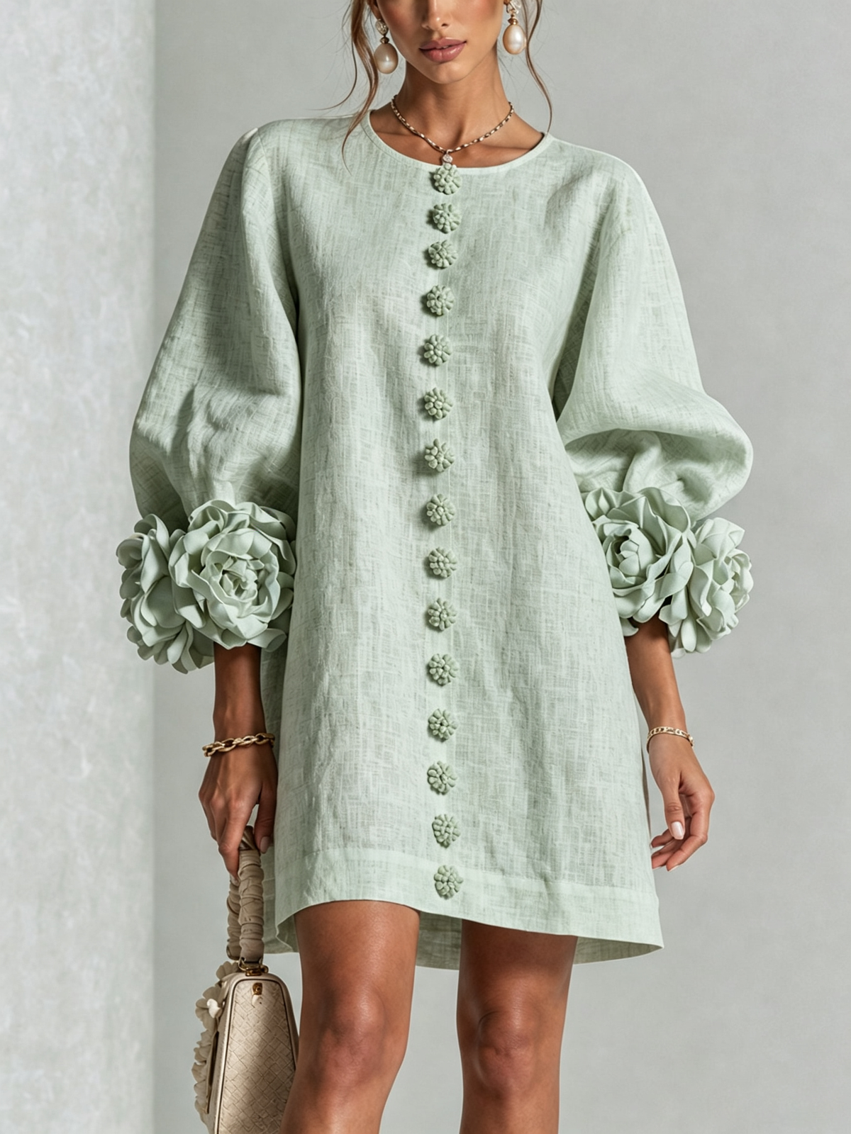 Close front view of the pale mint green dress, showing the line of flower buttons and big flower cuffs. 31