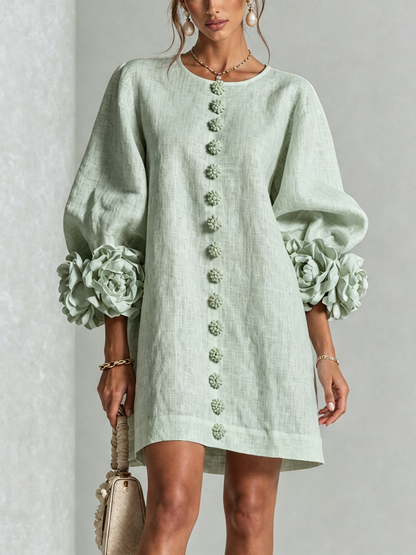 Close front view of the pale mint green dress, showing the line of flower buttons and big flower cuffs. 31