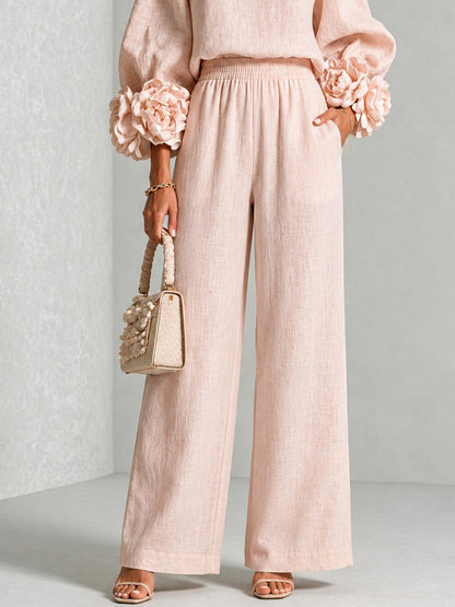 Close-up of the pink wide-leg trousers from the waist down, showing the elasticated waistband and side pocket 11