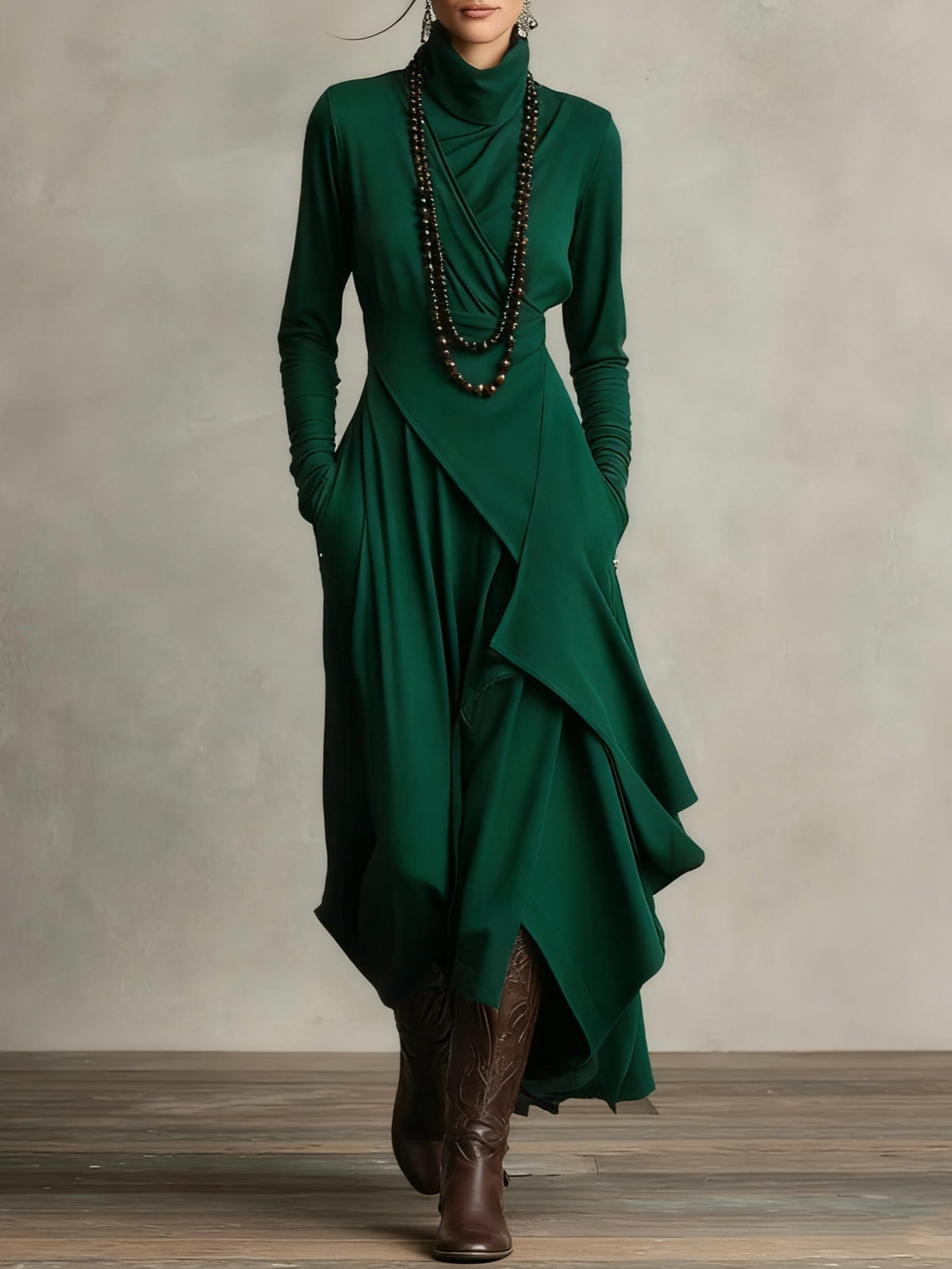 Front view of the dress in dark emerald green, styled with beaded necklaces and brown boots 11