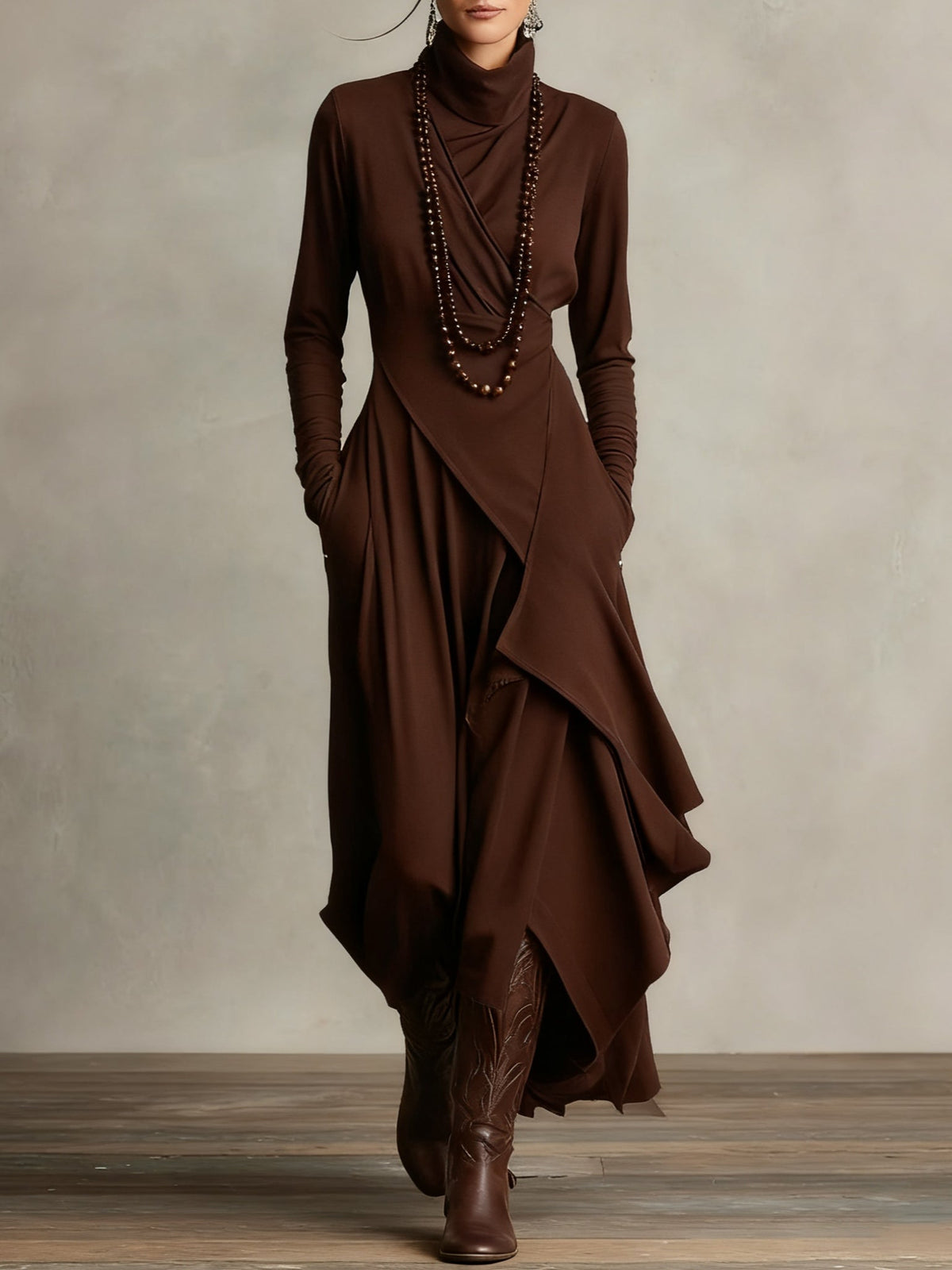 Front view of the dress in chocolate brown, styled with beaded necklaces and brown boots 9