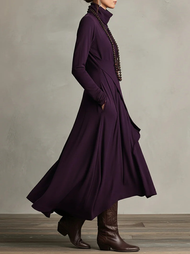 Side view of the purple dress, hand in pocket, showing the flared skirt and long sleeves 3