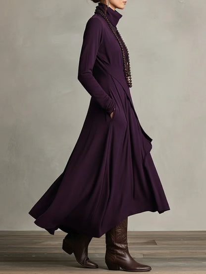 Side view of the purple dress, hand in pocket, showing the flared skirt and long sleeves 3