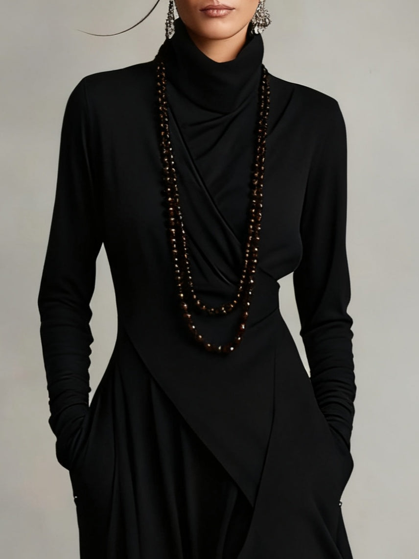 Close-up of the black bodice with draped turtleneck, wrap-style crossover and long ruched sleeves 7