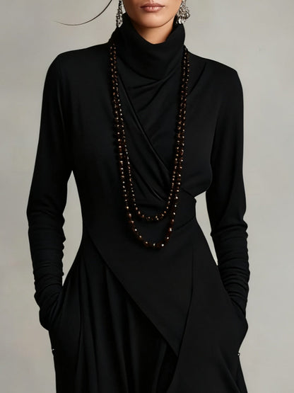 Close-up of the black bodice with draped turtleneck, wrap-style crossover and long ruched sleeves 7
