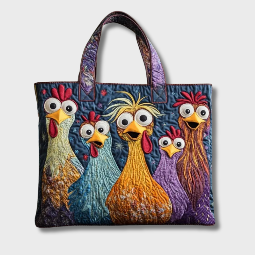 Same quilted chicken tote against a plain light grey background, showing the stitched appliqué hens and patterned purple handles in full. 2