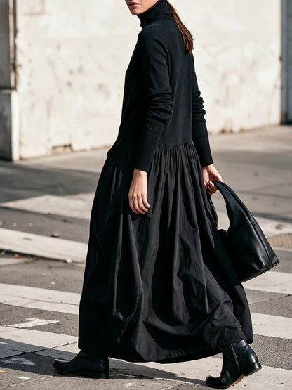 Side view of the black dress on a model crossing a street, showing the gathered skirt 2