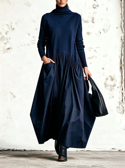 Front view of the dress in navy blue, worn with black boots and a black leather bag 6