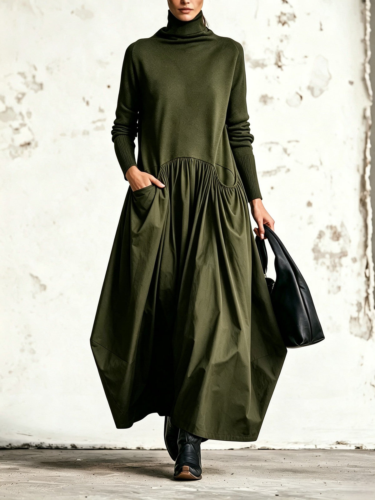 Front view of the dress in olive green, worn with black boots and a black bag 4