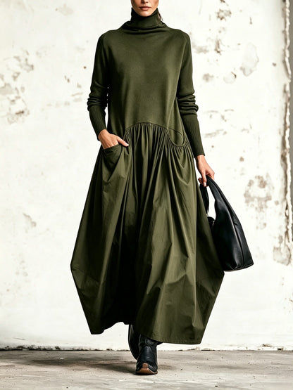 Front view of the dress in olive green, worn with black boots and a black bag 4