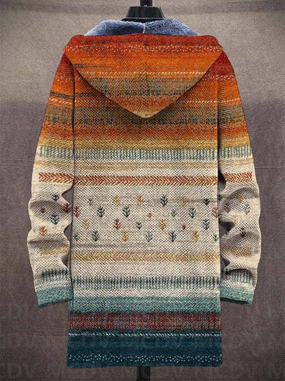 Back view of the hooded cardigan on a mannequin, showing the orange-to-teal striped pattern with small tree motifs 2