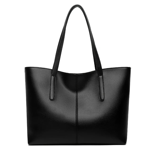 Black tote bag seen from the front on a plain white background, with two long straps 1