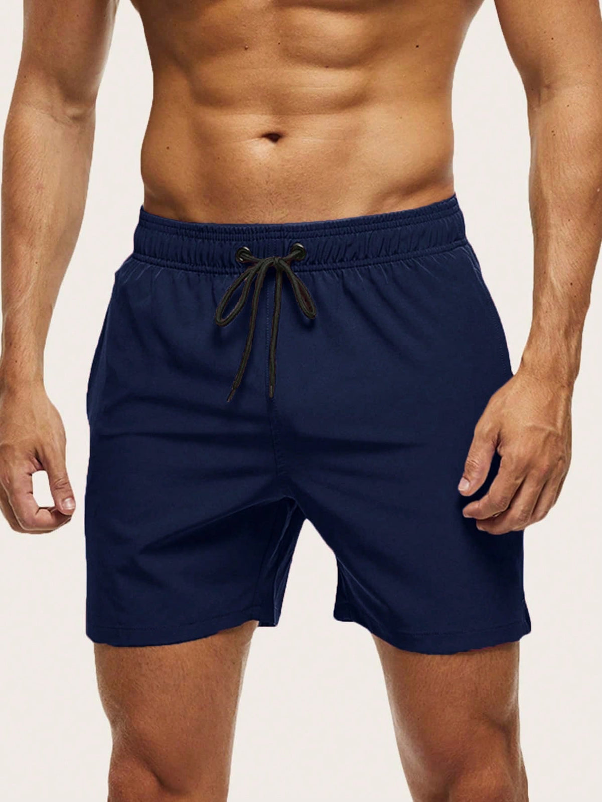 Front view on a model of navy blue swim shorts with elasticated waistband and black drawstring. 14