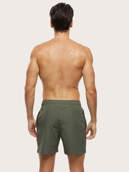 Back view of a model wearing olive green swim shorts, showing the plain rear and elasticated waistband. 3