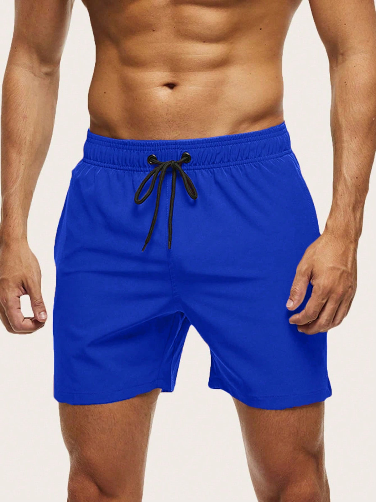 Front view on a model of royal blue swim shorts with an elasticated waist and black drawstring. 7