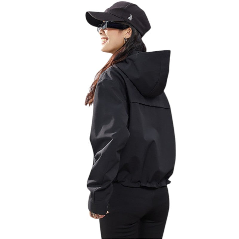 Back and side view of the black jacket, showing the hood and gathered hem, woman smiling 18