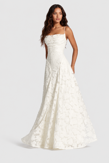 Model in ivory raised floral lace gown with thin straps and draped neckline, front view, skirt flowing out around her. 2