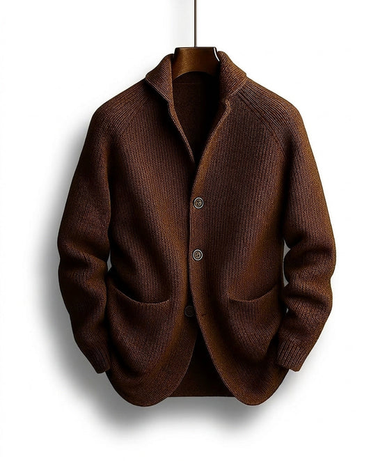 Brown ribbed cardigan hanging on a wooden hanger, showing the shawl collar, three buttons and patch pockets 1