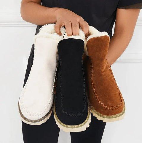 Three fleece-lined ankle boots held together in white, black and tan, showing the three colour options side by side. 7