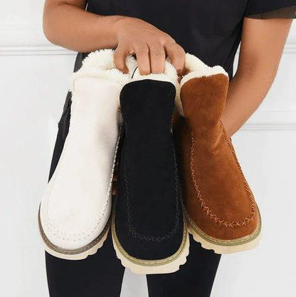Three fleece-lined ankle boots held together in white, black and tan, showing the three colour options side by side. 7