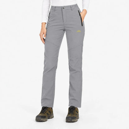 Front view of the trousers in light grey, worn with a white top and boots 9