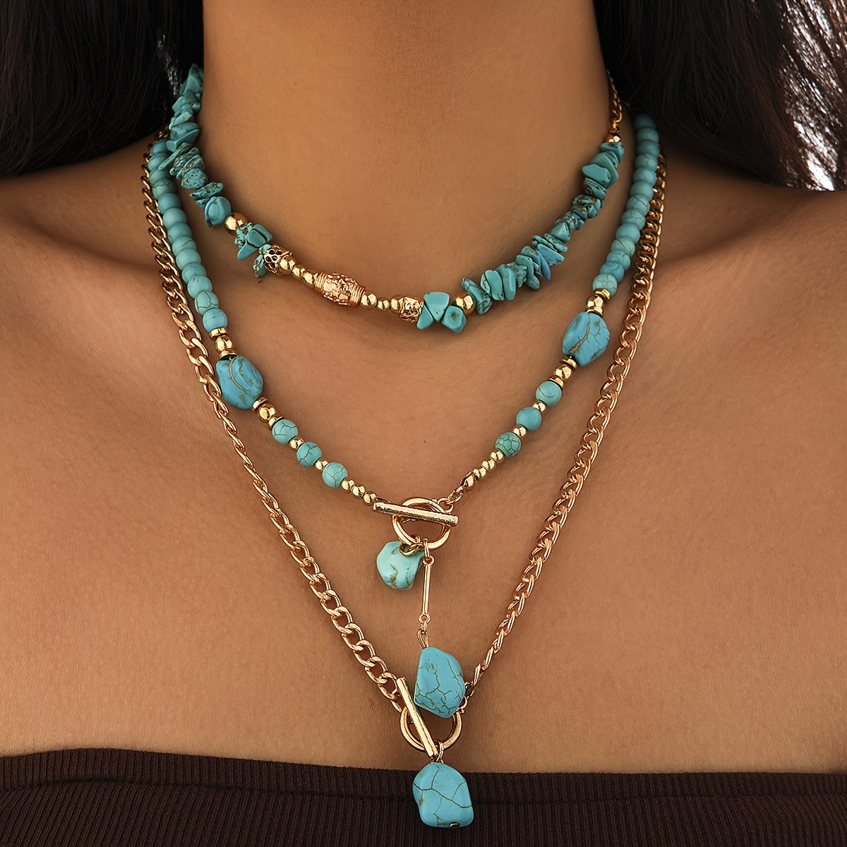 Model wearing the three layered necklaces, with the chip choker, beaded strand and long chain with stone pendants 6