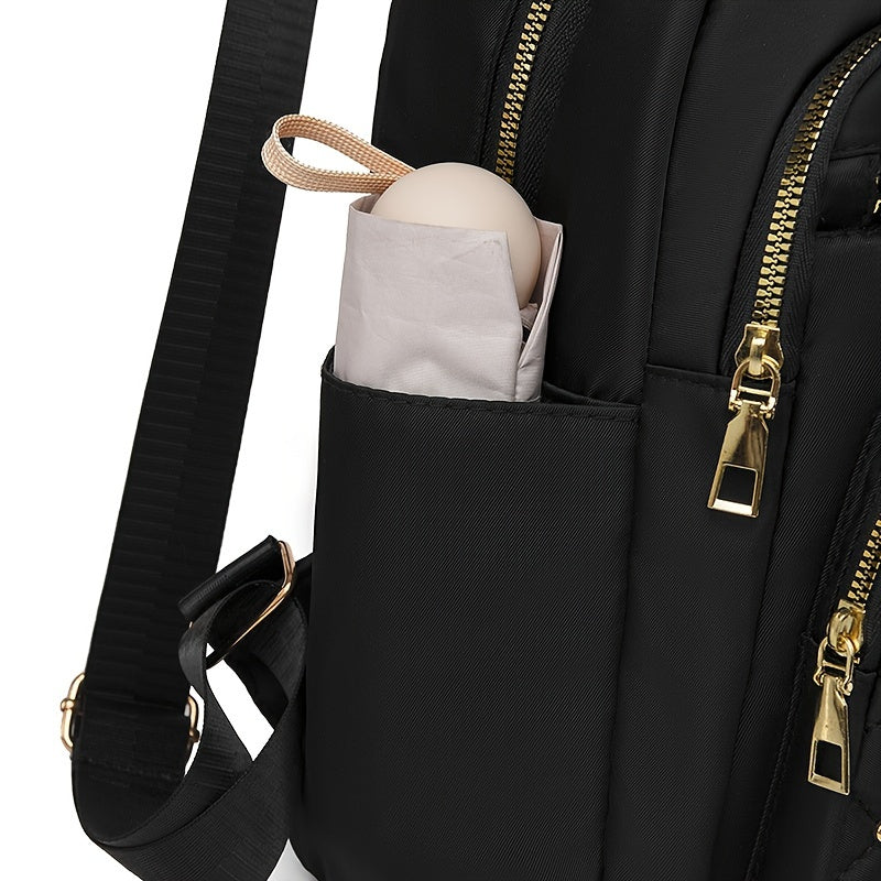 Close-up of the side pocket holding a folded umbrella, with gold zips and strap beside it 10