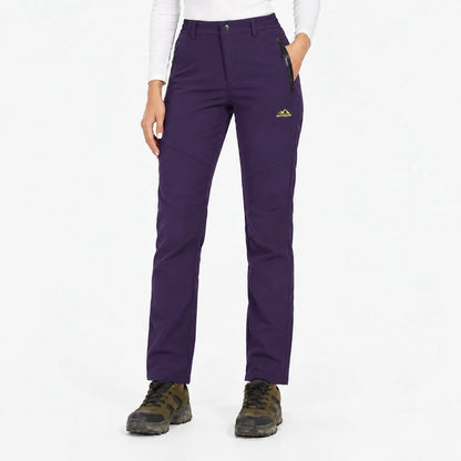 Front view of the trousers in a deep purple, worn with a white top 16