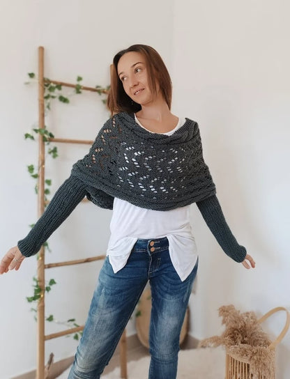 Dark grey wrap worn with both arms stretched out to the sides, showing the ribbed sleeves and cowl neckline. 5
