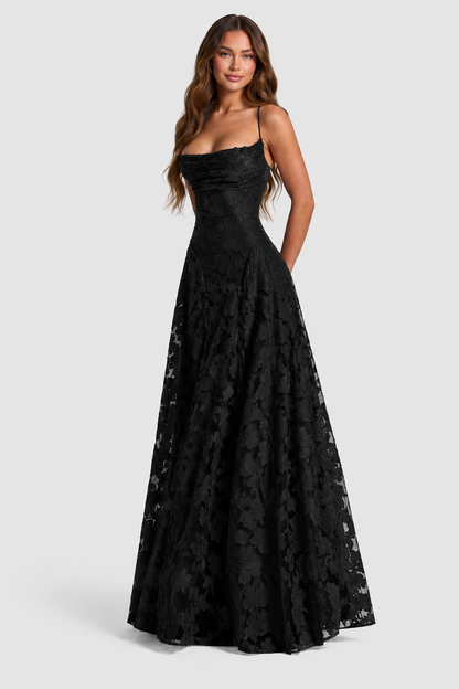 Black floral lace gown with draped neckline and spaghetti straps, model smiling in a front three-quarter pose. 10