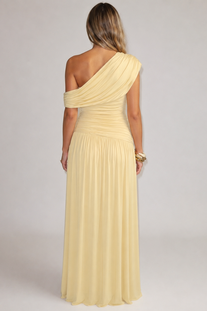Back view of the pale yellow dress, showing the asymmetric draped shoulder, ruched bodice and gathered full skirt. 2