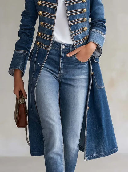 Close-up of the blue denim coat's front braiding, gold buttons, flap pockets and turned-back cuffs, worn with jeans and a brown bag. 6
