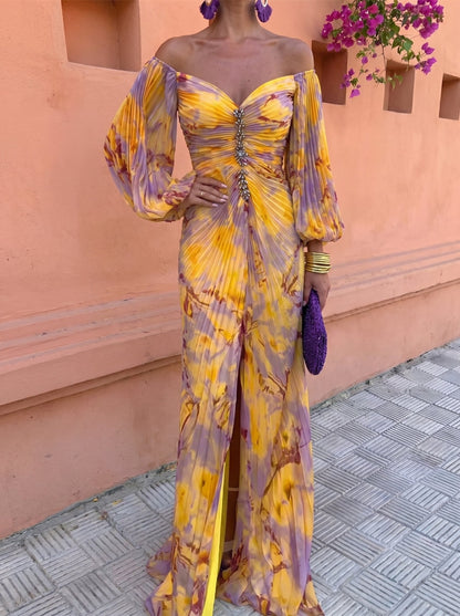 Close front view of the off-shoulder pleated bodice with crystal embellishment down the centre, balloon sleeves and front thigh slit. 2