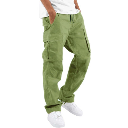 Model wearing light olive green cargo trousers with drawstring waist and flap pockets, with white t-shirt and trainers. 9