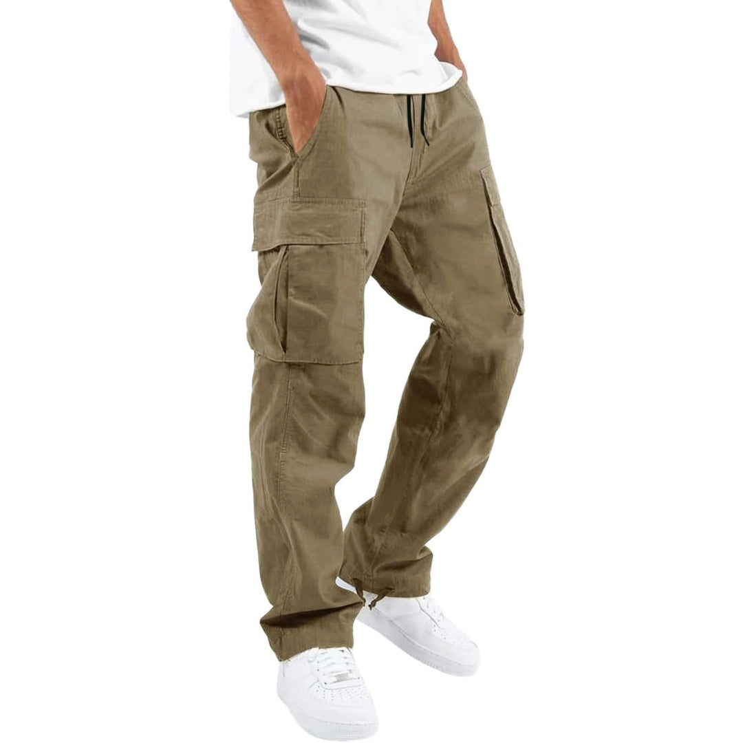 Model wearing khaki cargo trousers with drawstring waist and flap pockets, hands in pockets, with white t-shirt and trainers. 3