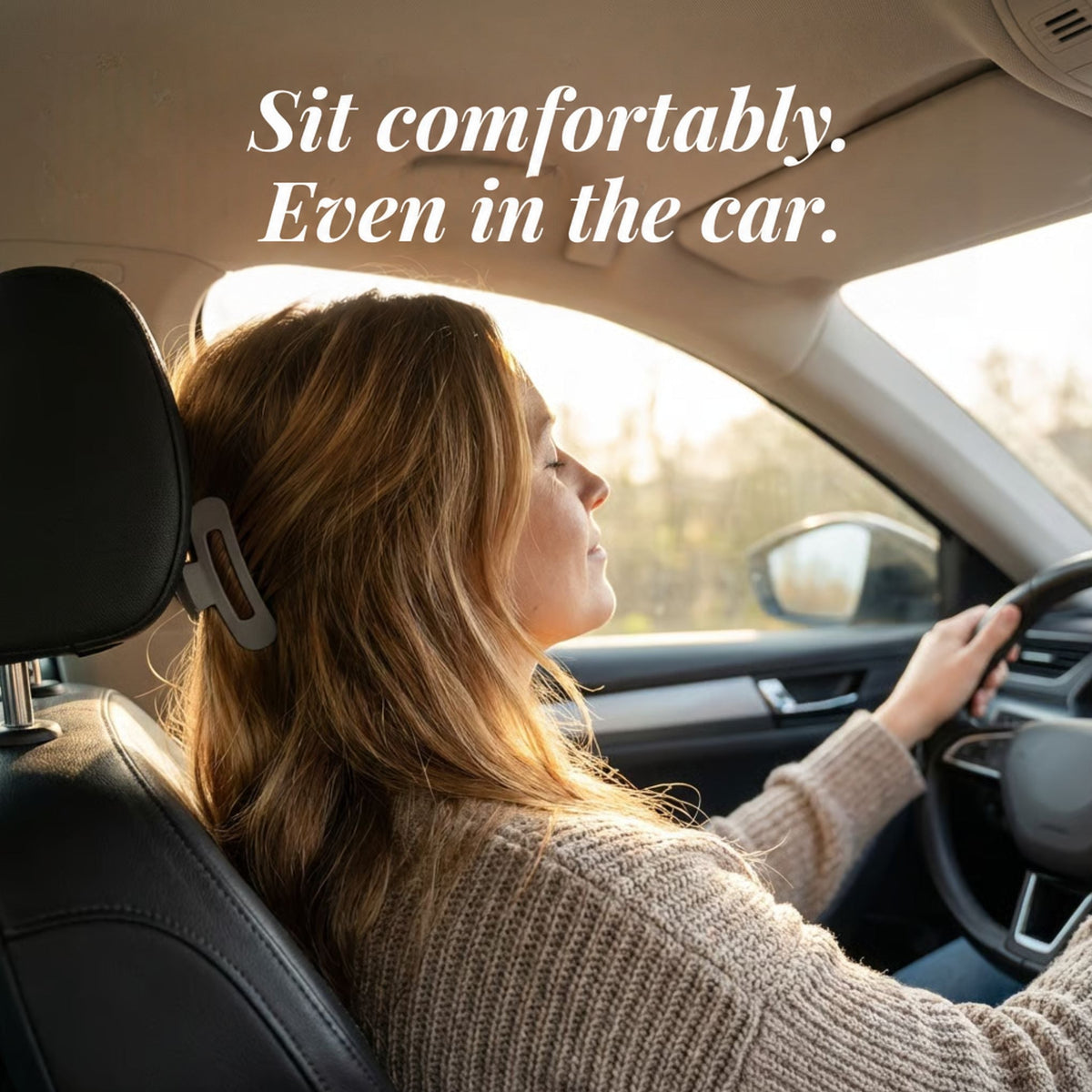 Woman driving with her hair fastened by a grey flat clip that sits comfortably against the headrest 2