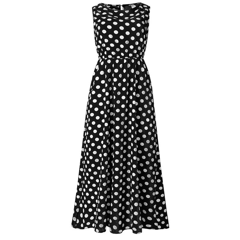 Black dress with white polka dots shown flat from the front, with elasticated waist and flared skirt 7