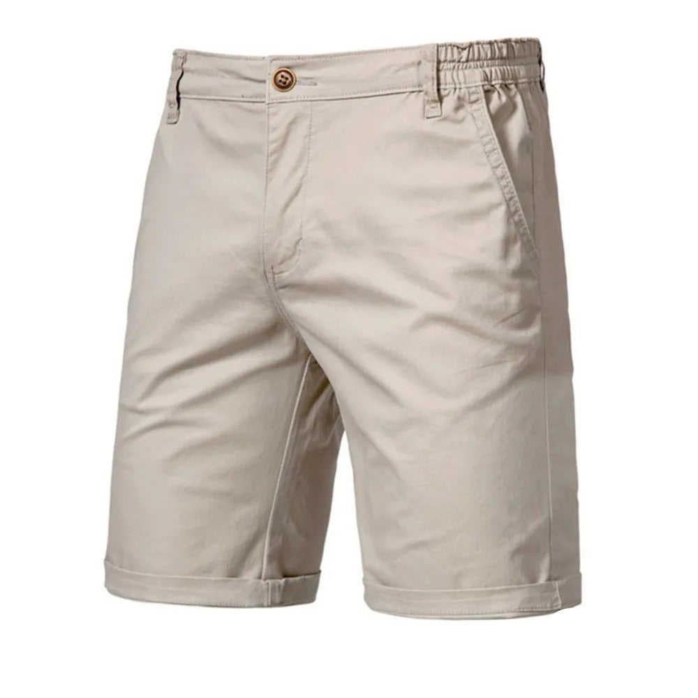 Front view of beige shorts with a single brown button, elastic back waist and rolled hems 1