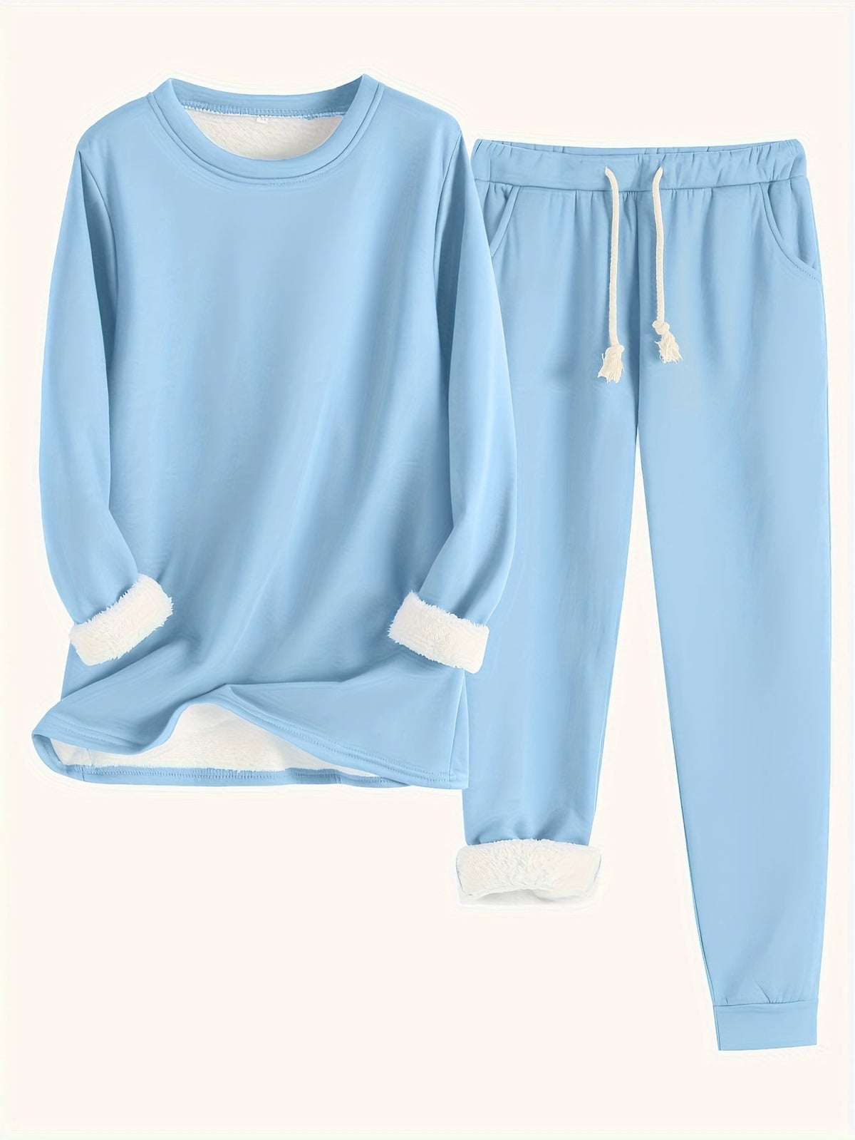 Flat lay of the set in sky blue, with soft white fleece lining at sleeves and ankles 12