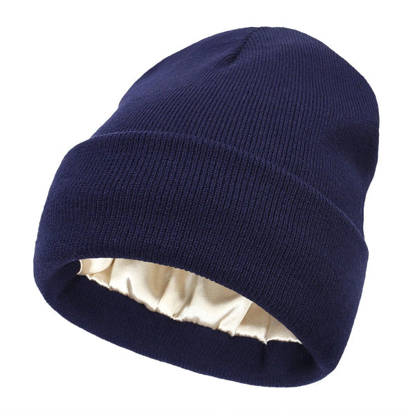 Navy blue ribbed knit beanie with folded cuff, showing the cream satin lining inside 11