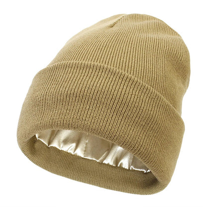 Sand-coloured ribbed knit beanie with cuff turned up, showing the glossy satin lining 8